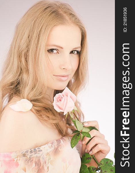 Portrait of young girl that holds delicate rose. Portrait of young girl that holds delicate rose