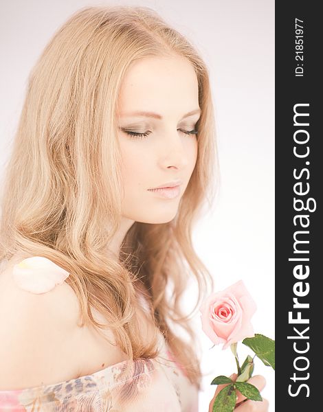 Portrait of young girl that holds delicate rose. Portrait of young girl that holds delicate rose