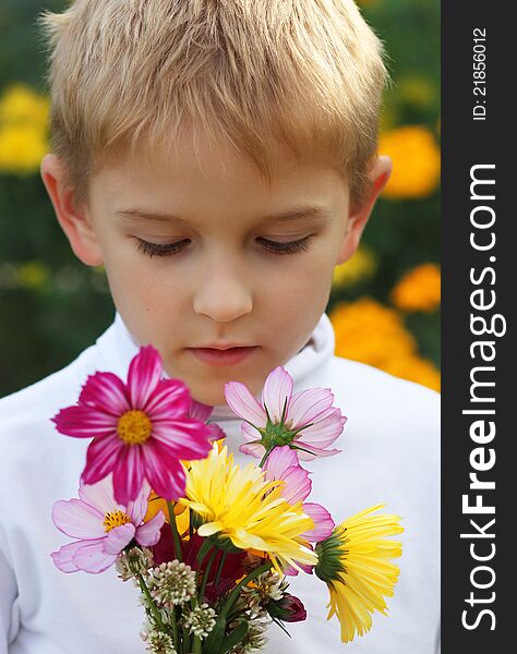 Boy with a bouquet on a white clothing