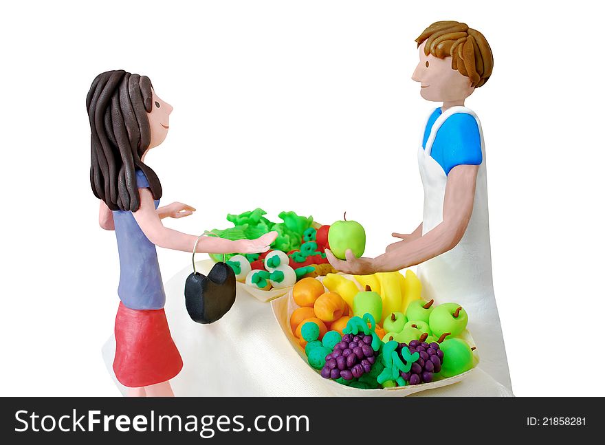 Greengrocer serving a young woman. Plasticine scene.