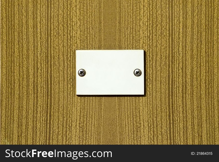 White screwed plate on the striped like wooden plastic texture background