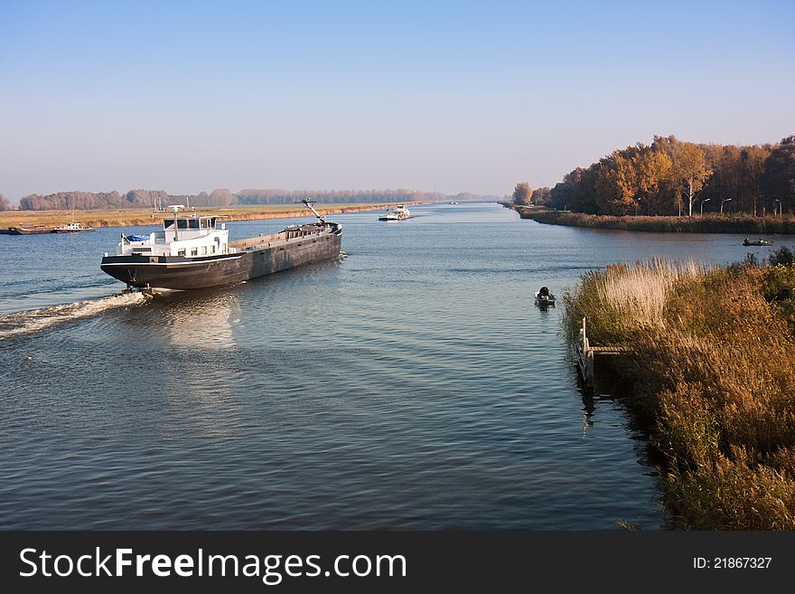 Big Dutch Canal And A Cargo Vessel