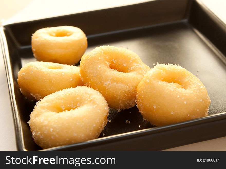 Donuts on a black dish