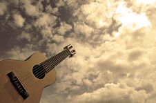 Photography Of Guitalele With Gray Sky In The Background Stock Image