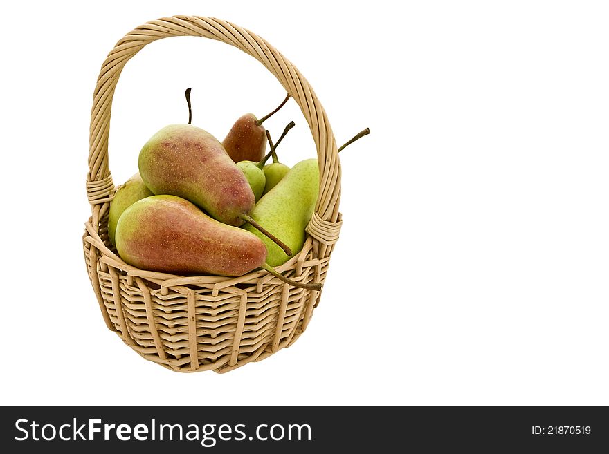 Mature delicious pear in a basket on a white background. Mature delicious pear in a basket on a white background.