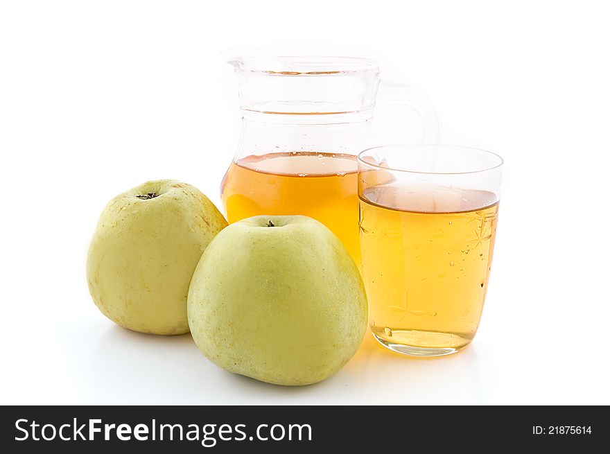 Jug and glass of green apple juice with fruit on white background