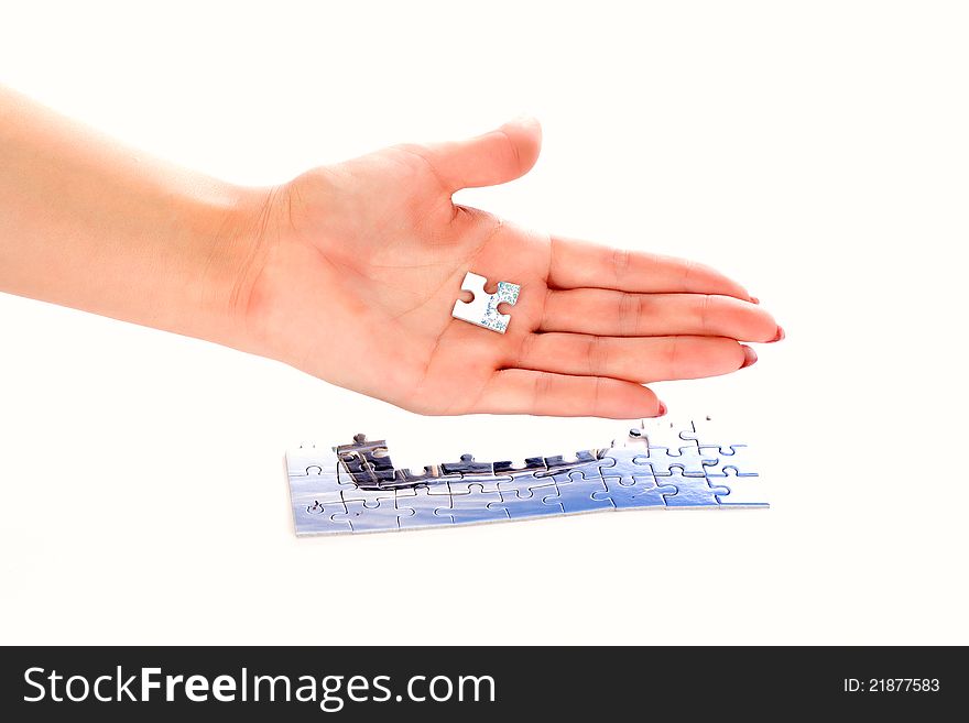 Hands of a woman holding a puzzle piece