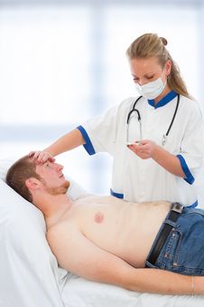 Young Doctor Checking Patients Temperature - Fever Royalty Free Stock Photo Young Doctor Checking Patients Temperature - Fever Royalty Free Stock Photo