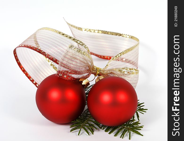 Red baubles with the ribbon on the white background. Red baubles with the ribbon on the white background