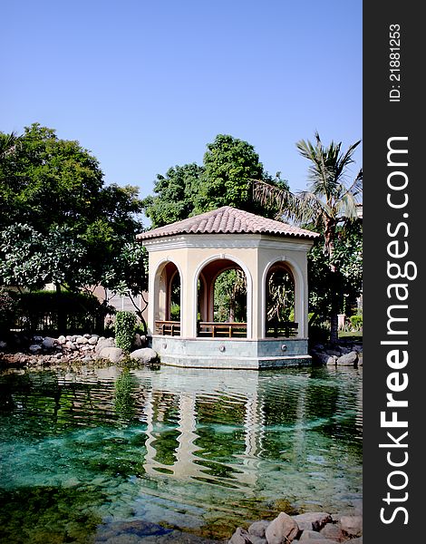 Pavilion in the garden and palm trees