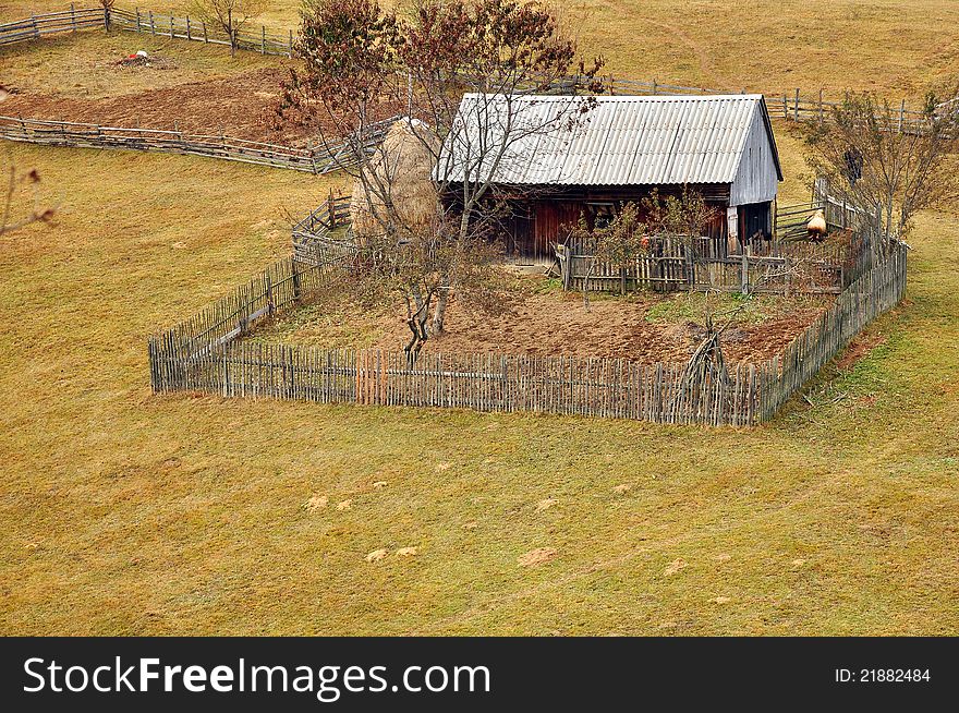 Generic transylvania rural household with old house and haycock