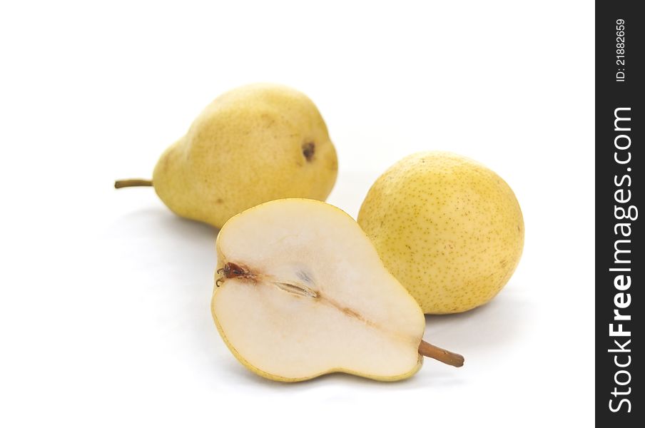 Two and a half pears on white background. Focus on front pear