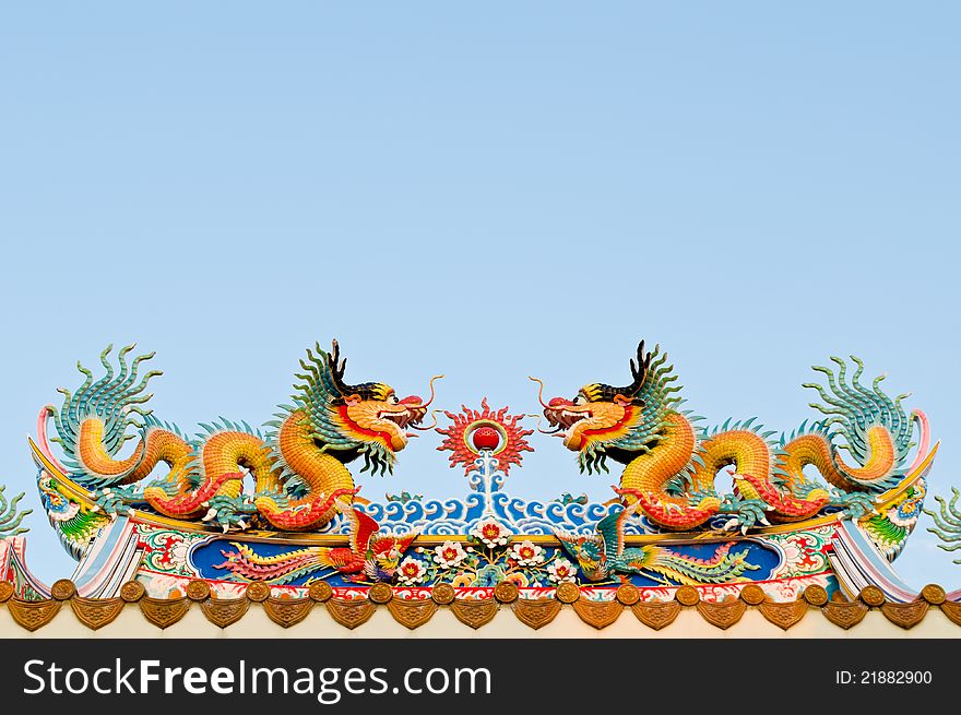 Twin dragon on the roof of shrine with blue sky background
