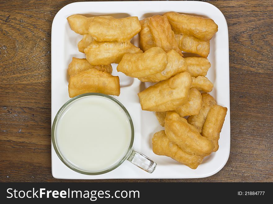 Deep fried dough sticks and a cup of soybean milk on tray