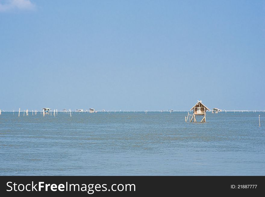 Small fisherman huts in the sea in Thailand