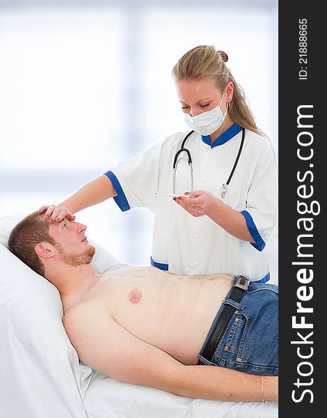 Young doctor checking patients temperature - fever