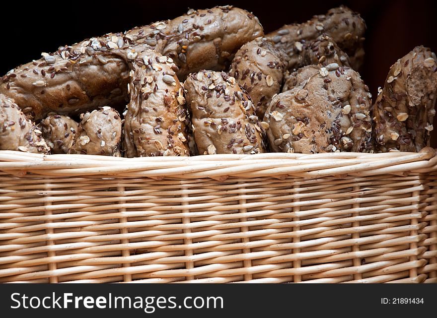 Freshly baked rustic bread rolls served in a basket. Freshly baked rustic bread rolls served in a basket.