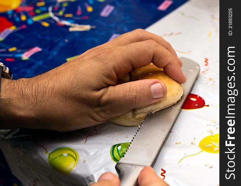 Man cutting bread for a birthday party snack