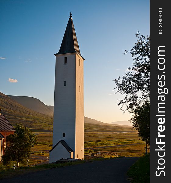 Icelandic rural church and beautiful valley in background.