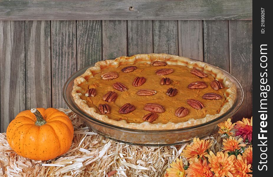 Autumn pumpkin pie with pumpkin and flower