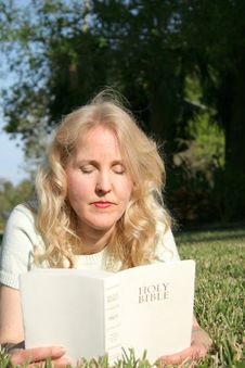 Woman Reading Holy Bible In Gr Stock Photo