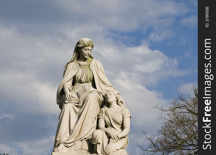 Cemetery monument stone statue woman and child. Cemetery monument stone statue woman and child