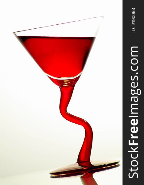 Glass with red liquid tilted at an angle. Glass with red liquid tilted at an angle