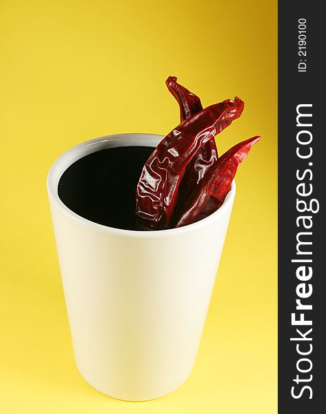 Very hot coffee - cup with a red chilli peppers. Very hot coffee - cup with a red chilli peppers