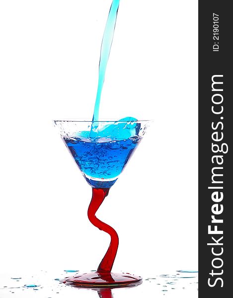 Blue liquid being poured into a glass. Blue liquid being poured into a glass