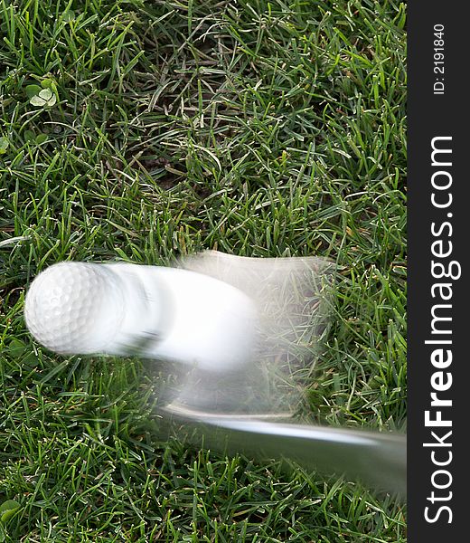 Close-up of golf ball launches off of 9-iron from rough. Close-up of golf ball launches off of 9-iron from rough.