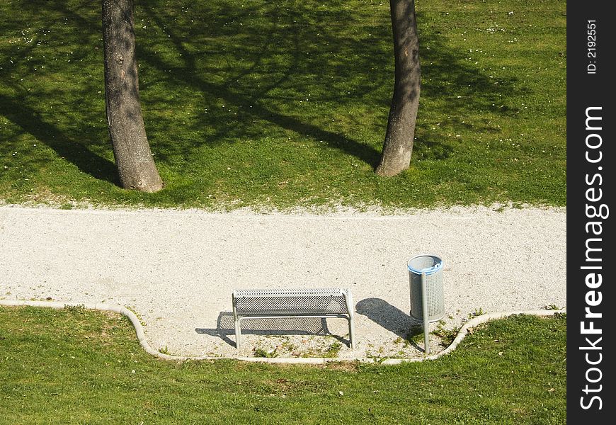 Empty park bench on the spring sunshine