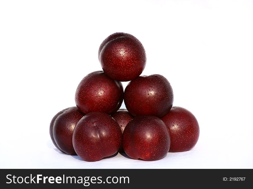 A stack of plums isolated on a white background. A stack of plums isolated on a white background.