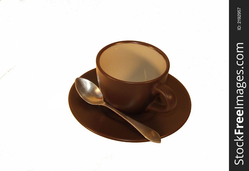 Isolated brown cup with silver spoon. Isolated brown cup with silver spoon