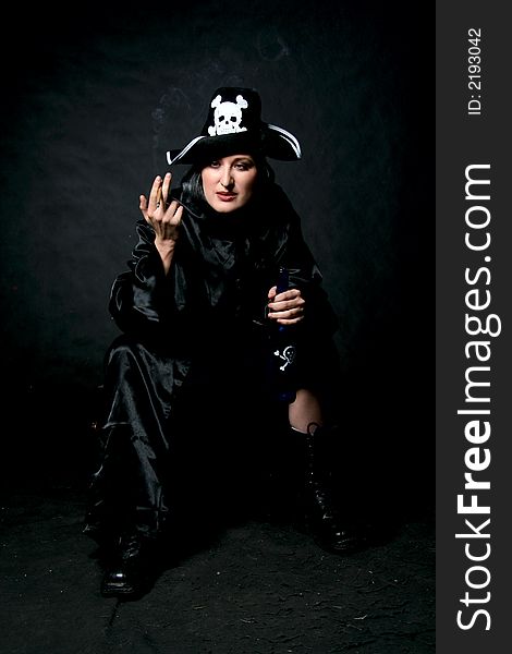 Women in pirate costume with bottle and cigarette. Make-up black background. Women in pirate costume with bottle and cigarette. Make-up black background.