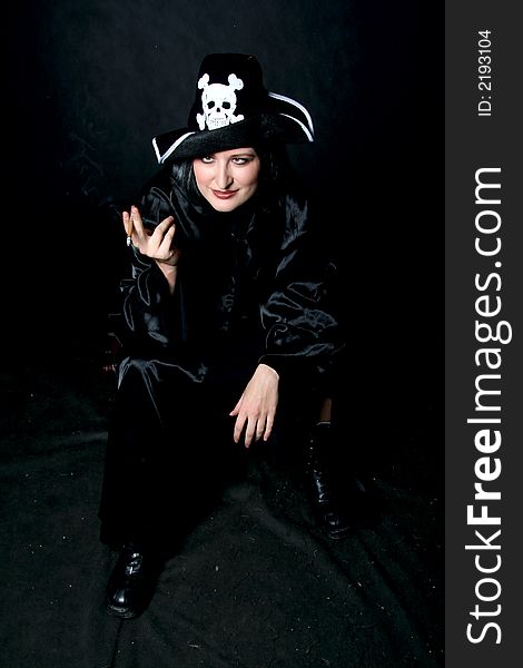 Women in pirate costume with cigarette. Make-up black background. Women in pirate costume with cigarette. Make-up black background.