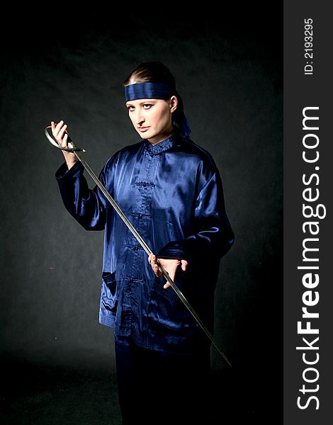 Women in chinese costume with epee: make-up. Women in chinese costume with epee: make-up