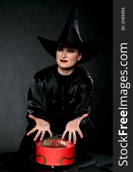 Women in witch costume with red box. Women in witch costume with red box.