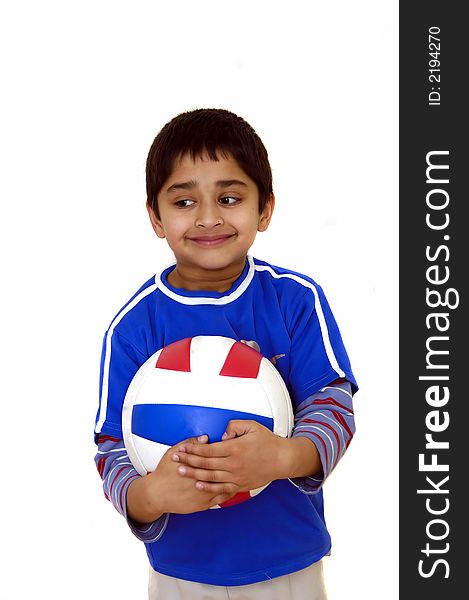 A young handsome kid holding a volleyball. A young handsome kid holding a volleyball