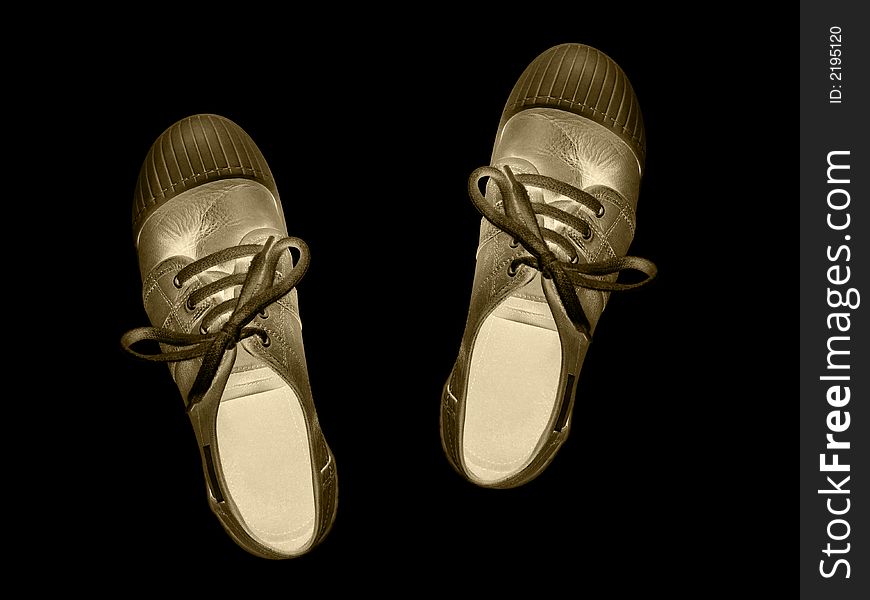 Golden shoes isolated on black background