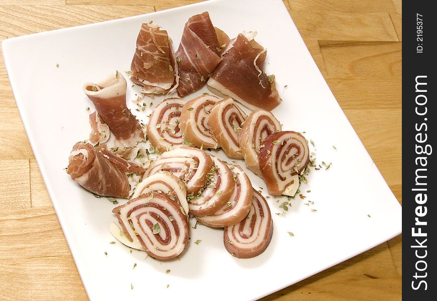 Italian delicacy of prosciutto wrapped in mozzarella. Sprinkled with oregano. Italian delicacy of prosciutto wrapped in mozzarella. Sprinkled with oregano.