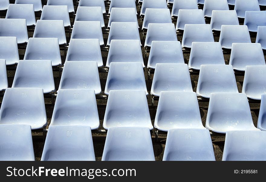 Many Empty Seats In Rows In An Outdoor Stadium. Many Empty Seats In Rows In An Outdoor Stadium