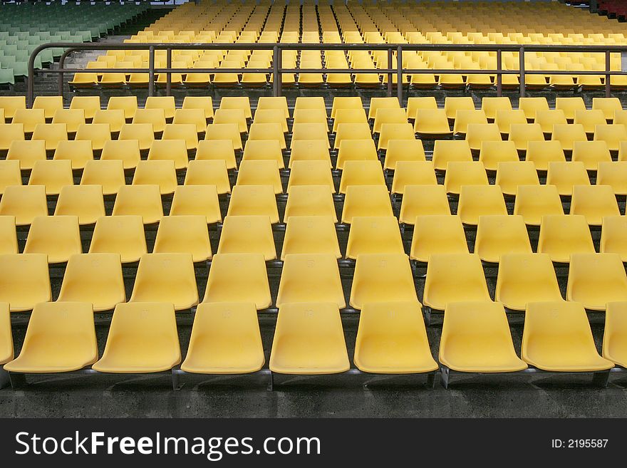 Many Empty Seats In Rows In An Outdoor Stadium. Many Empty Seats In Rows In An Outdoor Stadium