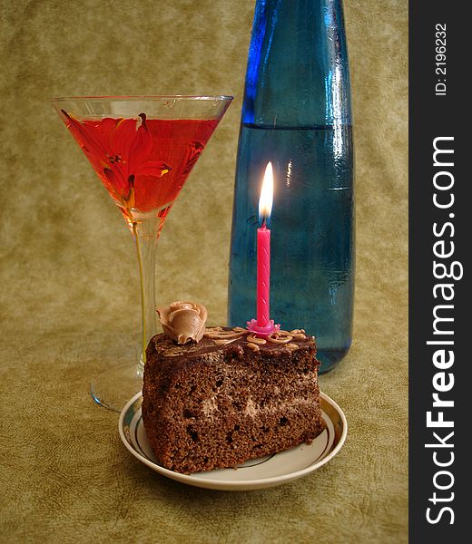Celebratory table (Chocolate cake with red candle and blue bottle)