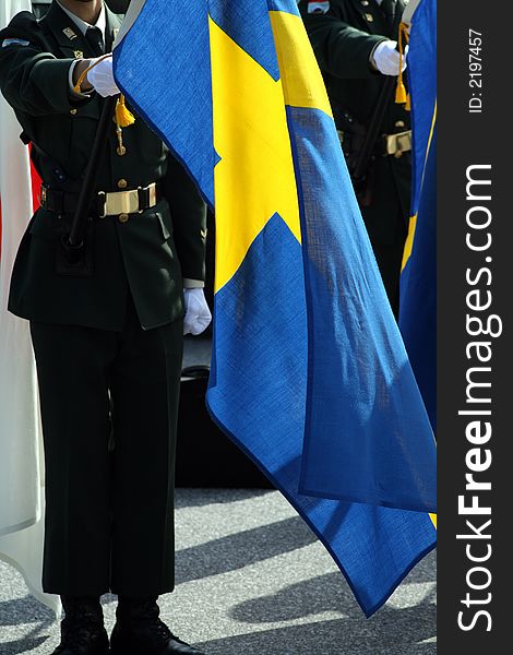 Soldier holding the Swedish flag