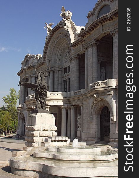 Front view of the marble construction of the Palace of Fine Arts with partial view of the gardens and fountains in front, down town Mexico city, Mexico Latin America. Front view of the marble construction of the Palace of Fine Arts with partial view of the gardens and fountains in front, down town Mexico city, Mexico Latin America