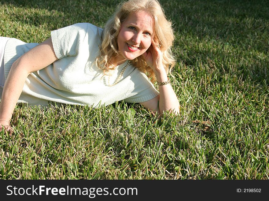 Shot of a woman laying in grass copyspace