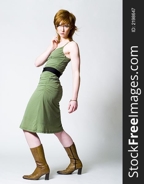 Read haired girl in green dress posing fashion style. Read haired girl in green dress posing fashion style