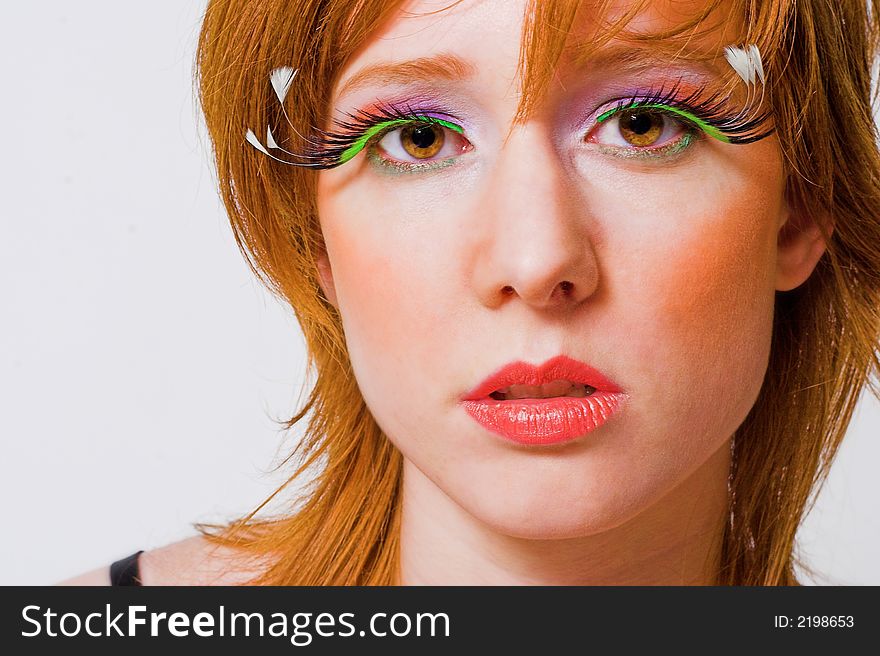 Portrait of a red haired girl with extreme make-up. Portrait of a red haired girl with extreme make-up