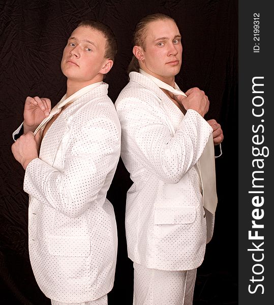 Two businessmen in white suits cost a back on a black background