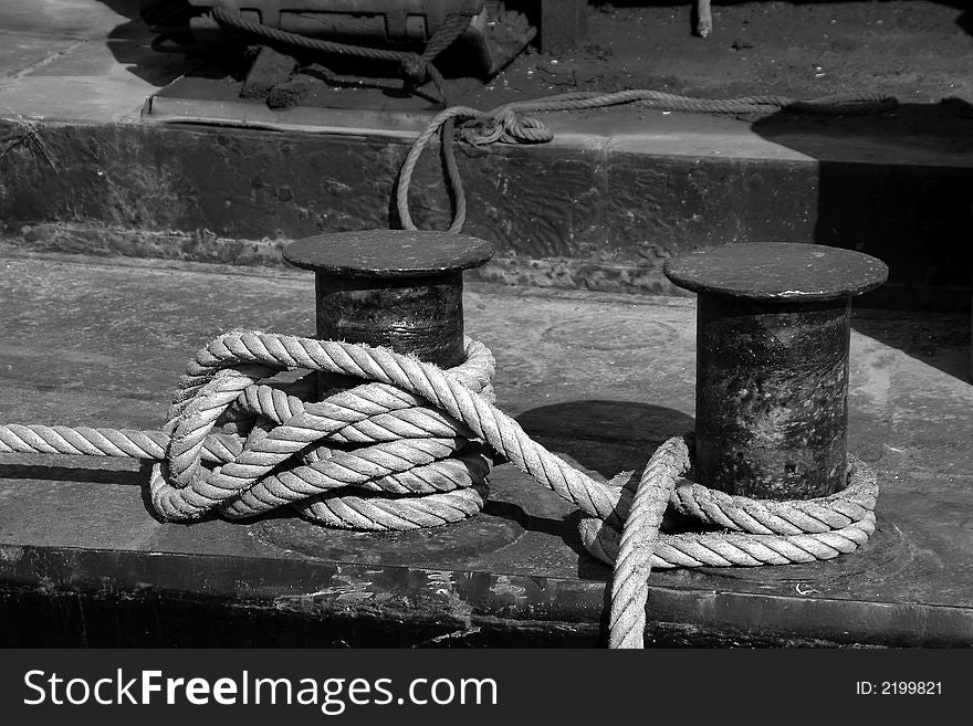 Mooring rope wrapped around two cleats on deck